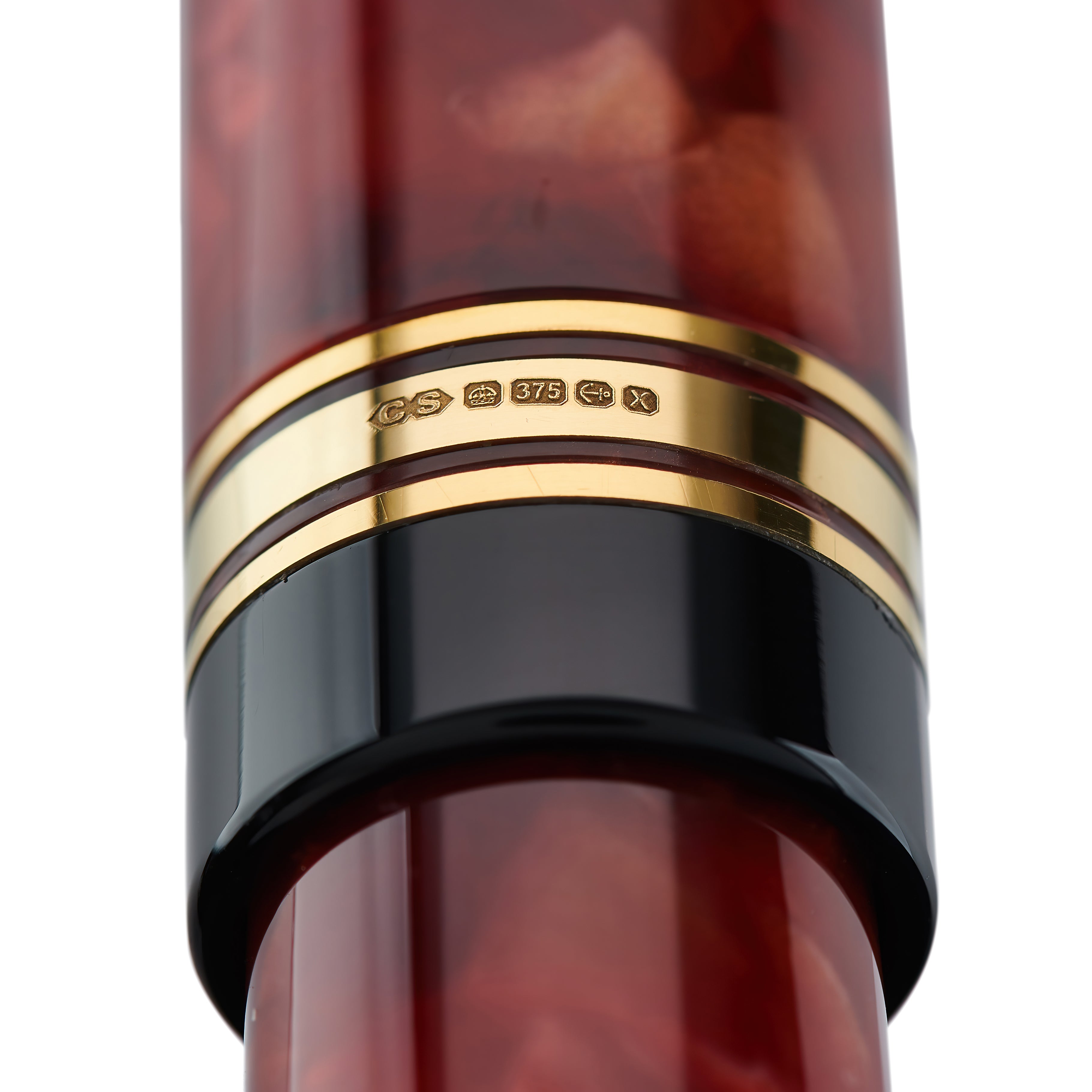 Close-up of the gold cap band hallmark stamped 375 on the Belliver Cherry Red